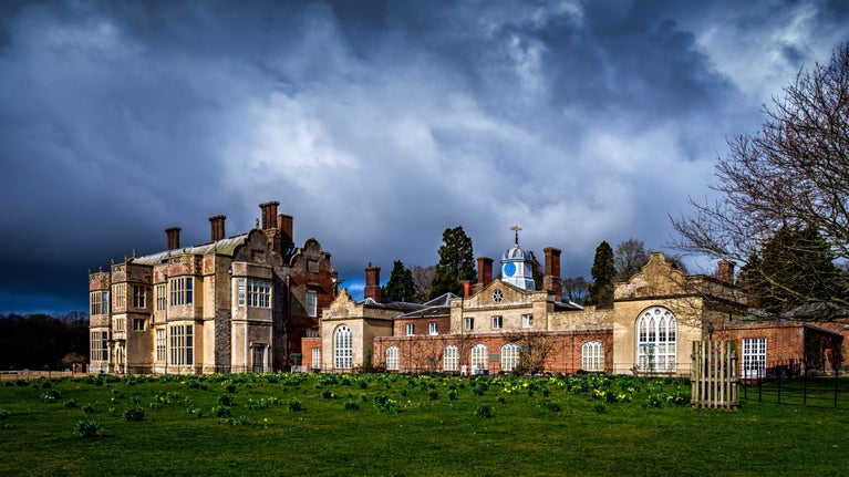 View of the house against dramatic clouds at Felbrigg Hall, Norfolk